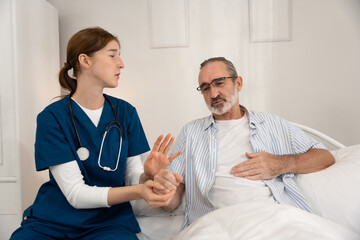 Obraz premium Home healthcare service for seniors with female nurse checking elderly man's heartbeat using stethoscope. Ideal for medical care, elder support, home visit, and heart health visuals.