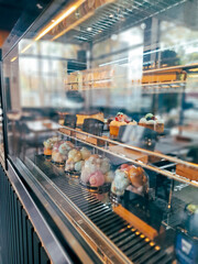 Wide View of a Modern Bakery Display Case Filled with Assorted Desserts.