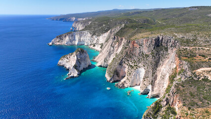 Aerial drone photo of scenic paradise bay with white rocky seascape forming small caves surrounded...