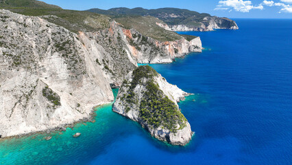 Aerial drone photo of scenic paradise bay with white rocky seascape forming small caves surrounded...