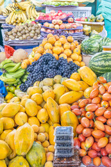 Colorful display of fresh fruits at the Otavalo market, Ecuador. A vibrant scene that conveys freshness, abundance, and natural flavor.