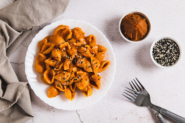 Spicy miso pasta shells on a plate on the table top view