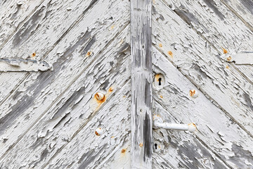 Door with handle and keyhole and weathered white paint background