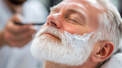 Elderly Man Relaxing During Professional Beard Shave with Shaving Cream