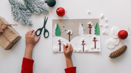 Child's handmade winter forest Christmas card with decorations on white background