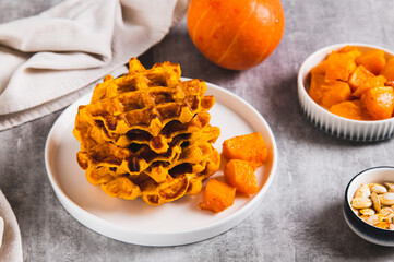 Homemade autumn pumpkin waffles on a plate on the table