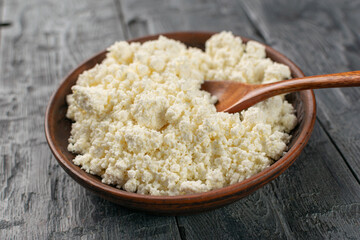 Fresh Organic Cottage Cheese in Rustic Wooden Bowl on Grey Wooden Table for Healthy Eating