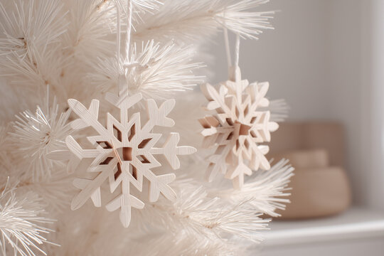Scandinavian Christmas decor, minimalist wooden ornaments on white fir tree, neutral beige background, natural light - Powered by Adobe
