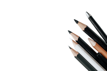 Assorted pencils and pens clustered in a corner against a black background