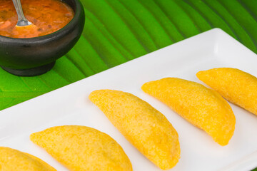 Colombian empanada with spicy sauce 
