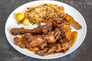 Free-range chicken prepared with its own blood sauce, known as 