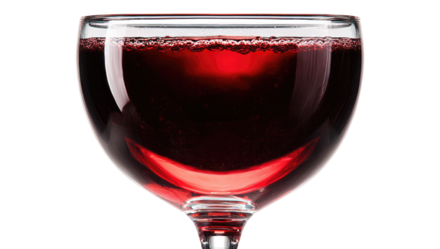 Close-up of a stemmed wine glass filled with red wine.  The glass is clear and has a wide bowl,  showing the ruby-red liquid with bubbles along the rim