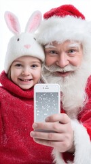 Caucasian elderly male santa and caucasian child enjoying festive selfie in winter attire