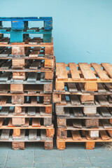 Pile of weathered euro pallets showing signs of wear and age.