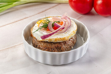 Beefsteak chop with roasted egg