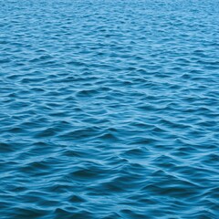 Obraz premium Bright blue sea water surface texture featuring rhythmic waves and reflections under natural sunlight, showing the vast saltwater body ,liquid ,environment ,texture