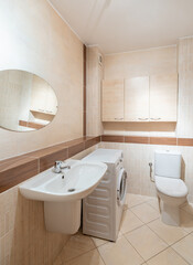 Modern Home Bathroom With Sink, Washing Machine, and Stylish Wooden Accents