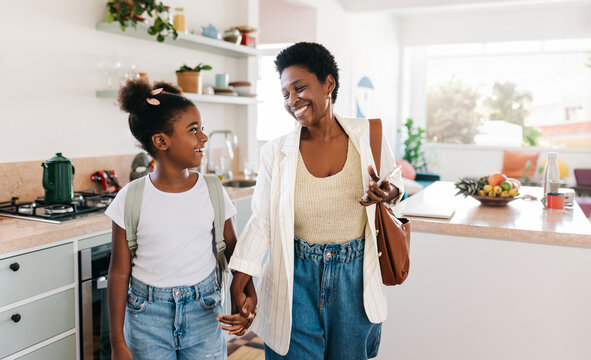 Ready for the day: Mother and daughter leaving the house together in the morning