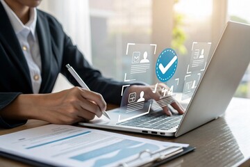 Businesswoman using laptop with digital verification icons. Online identity authentication, approval process, and data security concept for technology, corporate compliance, and business trust.