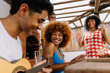 Friends enjoying music and laughter outdoors on a Saturday afternoon