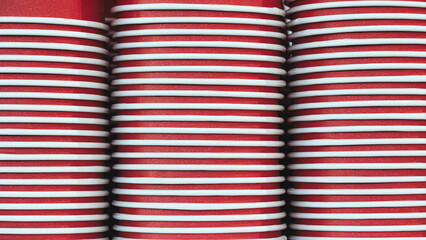 Red paper cups are stacked and ready to be used for selling juice, water, coffee or other fast food drinks.