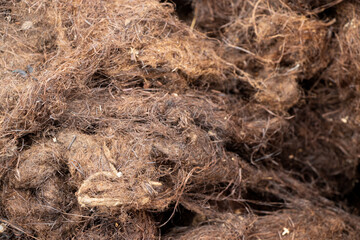 Close-up of dirty, old brown vegetable fiber for insulation, sealing cracks, furniture padding