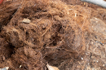 Close-up of dirty, old brown vegetable fiber for insulation, sealing cracks, furniture padding