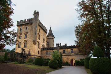 Fototapeta premium Exterior of the medieval castle of Puymartin with its towers and keep in the Dordogne region of France