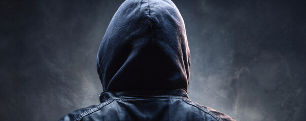 Hooded figure representing anonymity, cybercrime and digital security threats