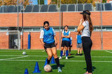 Obraz premium Women's soccer team training with coach on field