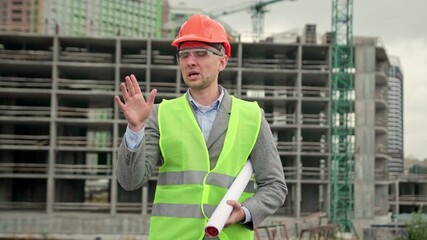Construction supervisor instructing somebody during new building site inspection