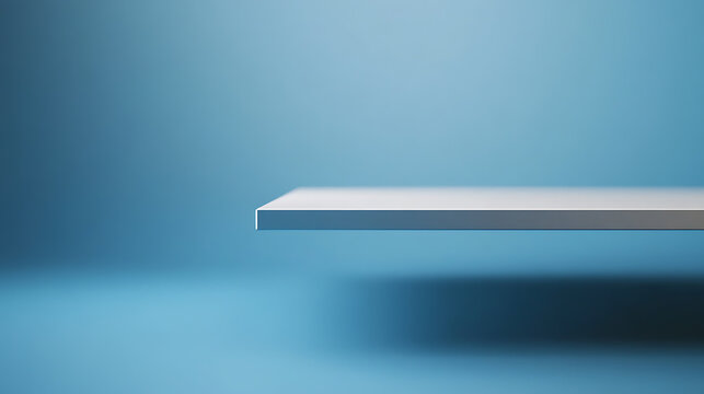 A minimalistic product placement scene with a crisp white shelf in front of a light blue backdrop. The setup offers a clean, versatile space for showcasing items.