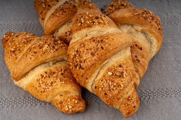 Delicious croissant with nut crumbs, sweet French bakery