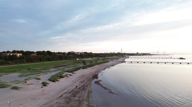 Aerial footage of Ribersborg shoreline bathed in golden evening sun