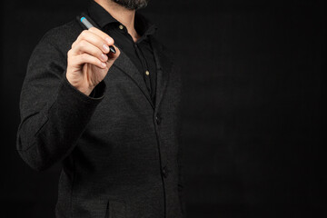 a business man on the left side of the screen writing on the space in front of him with his right hand and a digital pen