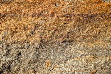 Natural brown stone surface with layered texture close-up
