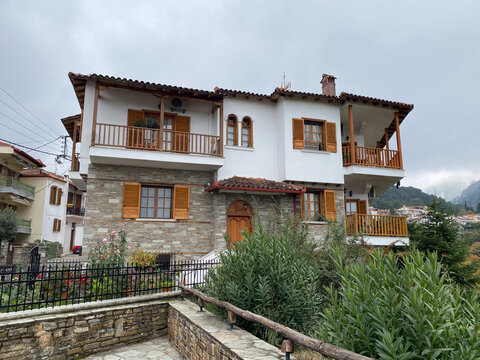 Charming traditional house with wooden shutters and stone details in scenic village