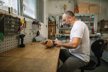 Orthopedic prosthetist assembling a prosthetic arm in workshop