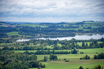 Obraz premium A cloudy autumn day near a castle at the foot of the Alps.