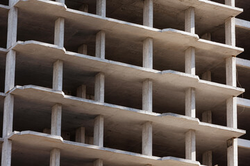Geometric concrete structure of a building under construction.
