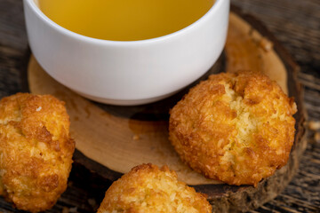 a group of sweet and delicious freshly made cookies for a tea party, a white cup filled with hot tea
