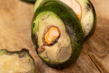 a ripe fresh green avocado cut into pieces, a green avocado with soft flesh cut into pieces long ago