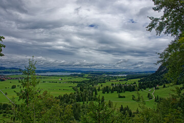 Obraz premium A cloudy autumn day near a castle at the foot of the Alps.