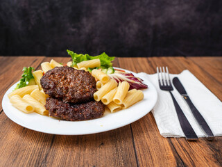 Meal with two tasty burgers, pasta and fresh salad and no sauce. Diet dinner for people with high blood sugar. Healthy food.