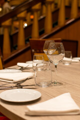 Mesa de restaurante preparada con platos y copas. Fotografía para bares y restaurantes.