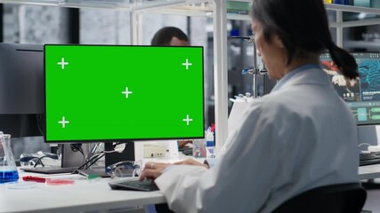Senior researcher working on isolated screen PC in lab, studying genomics information. ASian employee studies DNA strand mapping on mockup computer, contributing to scientific innovation, camera B - Powered by Adobe