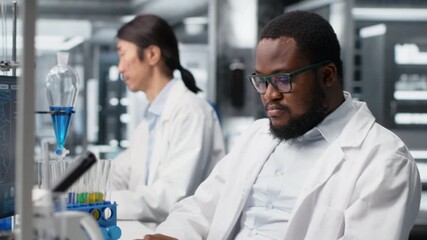 Stressed laboratory scientist using computer monitor, processing DNA patient data for clinical research. Anxious lab specialist looking at genetic analysis diagnostics on PC, camera B - Powered by Adobe
