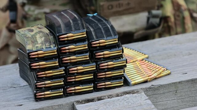 A stockpile of rifle magazines and ammo. Concept for strategic readiness, modern defense, and security operations