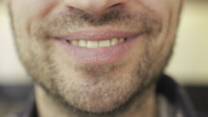 Close up of smiling teeth of bearded man posing at camera. Human emotions