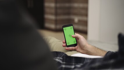 Man holding mobile phone with chroma key mock up green screen. Slow motion